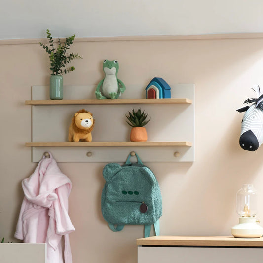 Obaby nursery wall shelf with two wooden shelves and hooks holding toys, plants, and a green backpack