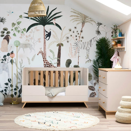 Obaby Thea nursery furniture set featuring a light wood crib and matching dresser in a stylish jungle-themed nursery